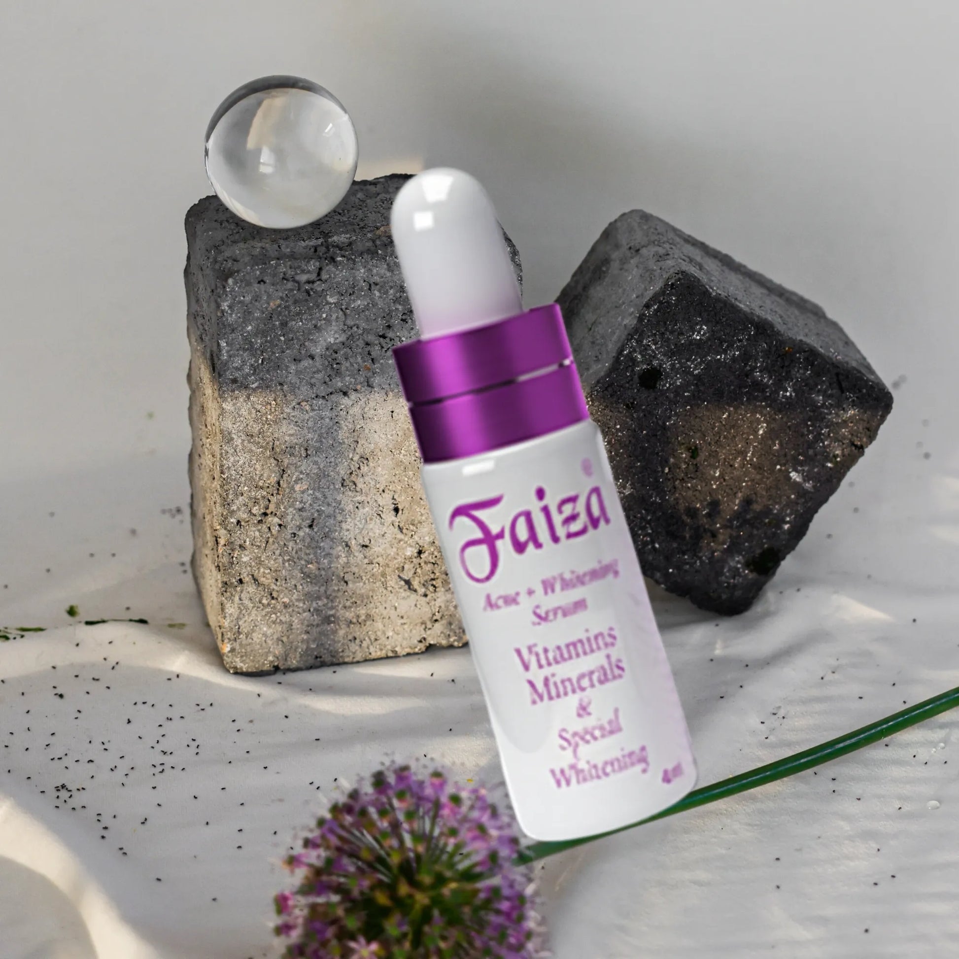 Faiza Acne + Whitening Serum vial placed on charcoal and rock for a clear skin, natural look.