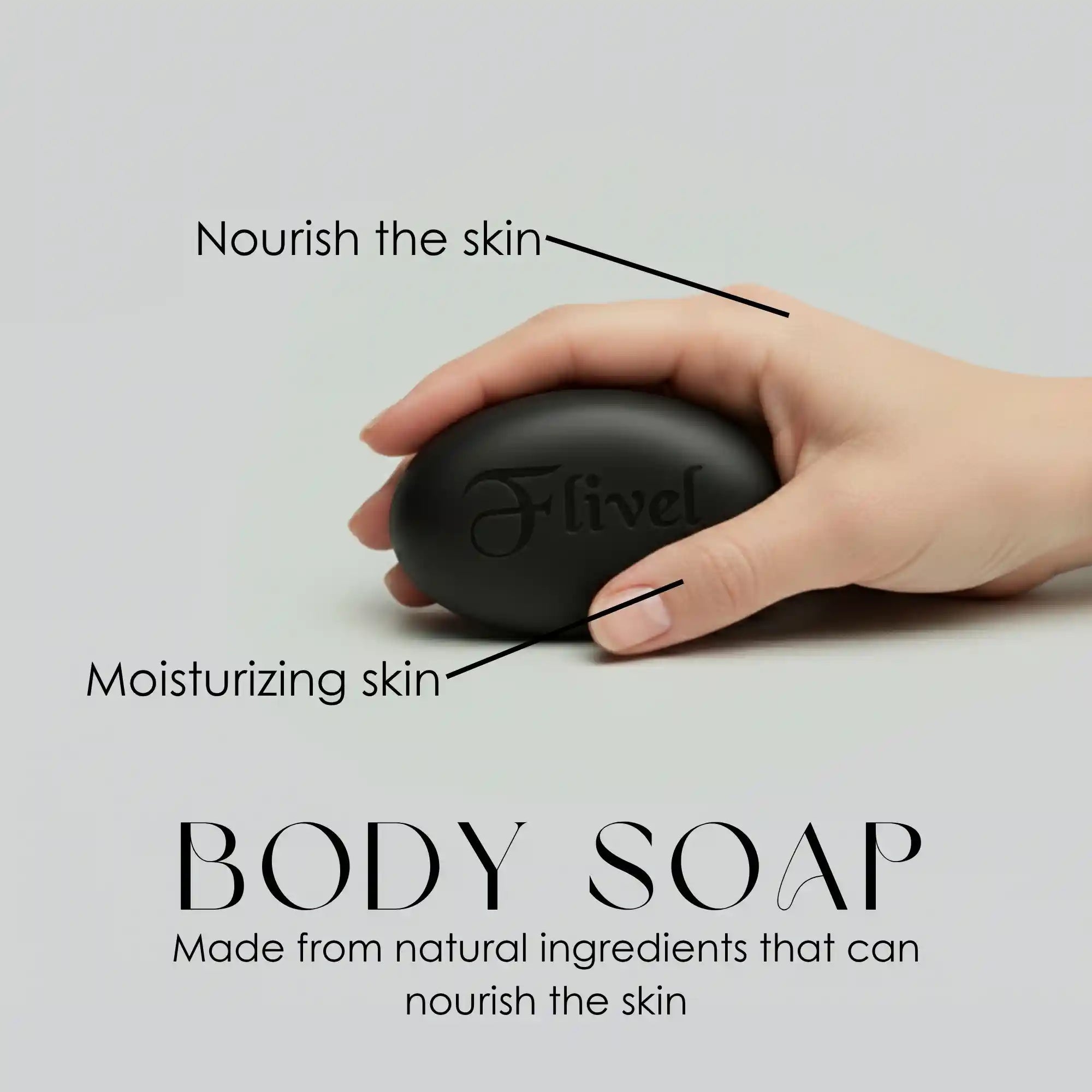 Flivel Black Soap bar being held in a hand, highlighting its natural moisturizing and skin nourishment benefits. This premium body soap is crafted from natural ingredients designed to deeply nourish, hydrate, and cleanse the skin, displayed on a sleek, minimalist gray background.